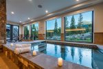 Indoor hot tub greeted with gorgeous views, TV also mounted on the wall